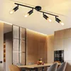 A modern dining room with a black ceiling light fixture. Voir les images du produit
