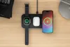 A Satechi Qi2 Trio wireless charging pad is shown on a wooden desk, charging an Apple Watch, AirPods, and an iPhone. Náhľad obrázku produktu