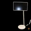 A white LG Lifestyle TV on a stand against a black background. Voir les images du produit