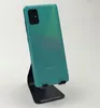 A teal Samsung Galaxy A51 smartphone is displayed on a black stand against a white background. Produktbild-Vorschau