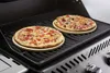 Two pizzas are being grilled on a barbecue. Produktbild-Vorschau