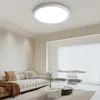 A modern living room with a sofa, coffee table, and a ceiling light. Produktbild-Vorschau