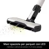 Close-up of a vacuum cleaner head with debris being picked up, against a white background. Anteprima dell’immagine prodotto
