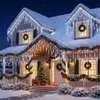 A snow-covered house decorated with Christmas lights and garlands for the holidays. Anteprima dell’immagine prodotto