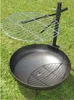 A metal fire pit with a grill grate on a grassy lawn. Produktbild-Vorschau