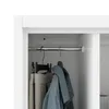 Close-up view inside a white cabinet with a hanging rod and clothes. Náhled obrázku produktu
