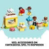 A collection of LEGO DUPLO figures and accessories, including a food stand, a hot dog, and cupcakes, set against a light blue background. Podgląd zdjęcia produktu