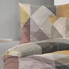 A close-up view of bedding with a geometric pattern. Produktbild-Vorschau