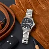 A watch, gloves, and car keys are arranged on a dark surface. Produktbild-Vorschau