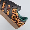 A close-up view of an Adidas Samba OG shoe with a leopard print accent. Produktbild-Vorschau