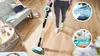 A person is using a cordless vacuum cleaner with a wet mop attachment in a living room. Produktbild-Vorschau
