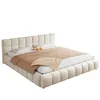 A beige upholstered bed with a headboard and frame, shown from a side angle on a white background. Anteprima dell’immagine prodotto