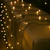 A string of warm white LED lights draped over a textured stone ledge. Náhled obrázku produktu