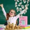 A young girl with glasses and pigtails is happily throwing money in the air, with stacks of coins and a pink piggy bank in front of her. Náhľad obrázku produktu