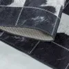 A close-up view of a rug with a patchwork design. Produktbild-Vorschau