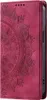 A close-up view of a red flip phone case with a mandala pattern embossed on it. Produktbild-Vorschau