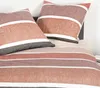 A close-up view of a bed with pillows and a duvet cover. Produktbild-Vorschau