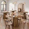 A dining room setting with multiple wooden tables and chairs, decorated with floral arrangements. Náhľad obrázku produktu