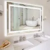A well-lit bathroom with a large, illuminated mirror reflecting a bathtub and shower area. Produktbild-Vorschau