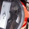 A close-up view of the internal components of a red electric heater, showing the fan blades and part of the casing. Náhled obrázku produktu