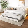 A beige daybed with a pull-out trundle and storage drawers, set up in a room with a plant and artwork. Voir les images du produit