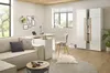 A modern living room/office space with a sofa, desk, chair, and storage unit. Produktbild-Vorschau
