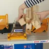 Hands holding wooden pieces over a woodworking machine. Produktbild-Vorschau