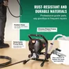 A person's legs and feet are visible on the left, holding a hose connected to a paint sprayer. The paint sprayer is the main focus, with callouts highlighting its features. Náhľad obrázku produktu