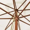 Close-up view of the internal structure of an open umbrella, showing the wooden mast and metal ribs. Produktbild-Vorschau