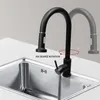 A black kitchen faucet with a pull-out spray head is shown over a stainless steel sink. The faucet is depicted in two positions to illustrate its 360-degree rotation capability. Náhled obrázku produktu