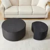 Two ottomans are placed on a rug in front of a sofa. Produktbild-Vorschau