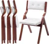 A set of four folding chairs, with one chair unfolded and displayed prominently. Podgląd zdjęcia produktu
