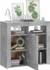 A grey sideboard with two open doors, displaying shelves with various decorative items and books. Anteprima dell’immagine prodotto