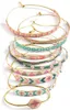 A stack of beaded bracelets with gold string. Podgląd zdjęcia produktu