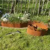 Two rusty metal garden edging pieces are shown in a garden setting, with a hammer lying on the grass in the foreground. Produktbild-Vorschau
