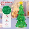 A decorative LED Christmas tree with a star on top, set against a snowy outdoor background with a house. Náhled obrázku produktu