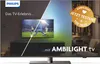 A Philips TV displaying a soccer game, with ambient lighting effects on the wall behind it. The image also features promotional text and a circular badge. Produktbild-Vorschau