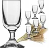 A large wine glass is shown in the foreground, with a set of six smaller wine glasses and a bundle of wheat stalks in the background. Podgląd zdjęcia produktu