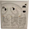 The image shows the back of a product box with instructions and feature descriptions in multiple languages. Produktbild-Vorschau