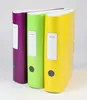 Three colorful binders standing upright. Voir les images du produit
