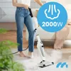 A person is using a white steam cleaner on a carpeted floor in a living room. Produktbild-Vorschau