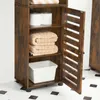 A wooden cabinet with open shelves, displaying towels, toilet paper, and a white storage bin. Náhled obrázku produktu