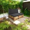 An outdoor seating area with a pallet sofa and cushions in a garden setting. Podgląd zdjęcia produktu