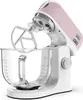 A pink and white Kenwood Kmix stand mixer with a glass bowl and beater attachment, shown against a white background. Voir les images du produit