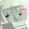 Close-up of a green baby stroller with a highlighted armrest. Náhled obrázku produktu