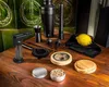 A collection of barware and smoking accessories laid out on a wooden table. Voir les images du produit