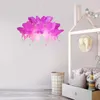 A child's bedroom with a pink butterfly-shaped pendant lamp hanging above a bed. Anteprima dell’immagine prodotto