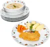 A stack of Christmas-themed bowls and plates, with a separate plate showing a meal. Náhled obrázku produktu