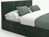 A close-up view of a bed with a green upholstered headboard and frame, white bedding, and green decorative pillows. Náhled obrázku produktu