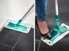 A collage showing a mop being used in two different scenarios: cleaning a corner and being stepped on to attach the mop head. Produktbild-Vorschau